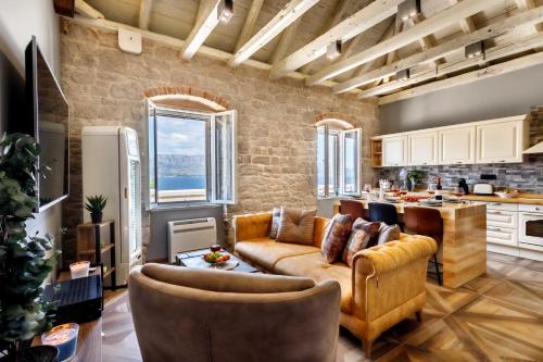 a large living room with a couch and a kitchen at St. Nicholas lighthouse - island of Brač in Pučišća