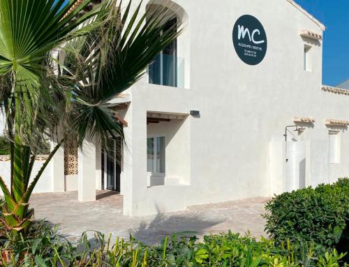 a white building with a sign on the side of it at Soul Beach Villa By Mc in Denia