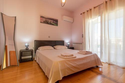 a bedroom with a bed with two towels on it at Rose Garden House in Kremasti