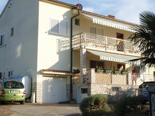 a white house with a car parked in front of it at Guest House Jasmin in Rovinj