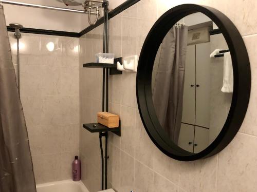 a bathroom with a large mirror and a sink at Industrial Design Bungalow – 2 min to Center, Wifi in Mytilene