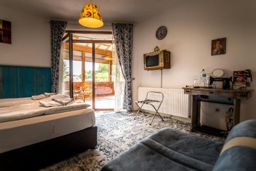 a room with a bed and a desk and a tv at Tihiat Kut Complex in Kyustendil