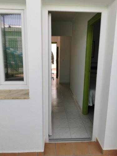 a hallway of a house with a green door at Hotel El Puntazo I in Mojácar