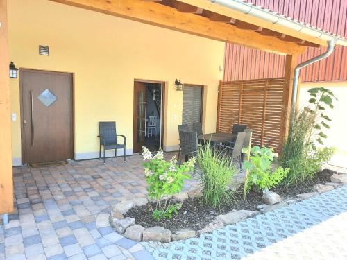 a patio with a table and chairs next to a building at Ferienwohnung Schoch in Rust