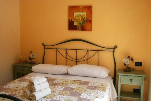 a bedroom with a bed with two pillows on it at L'Allegra Brigata in Finale Ligure