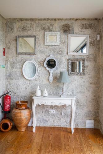 a room with a white table with a lamp on it at Casa d' Avó Marcelina - Casas de Campo in Arcos de Valdevez