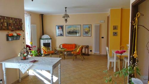 a living room with a table and chairs at L'Allegra Brigata in Finale Ligure