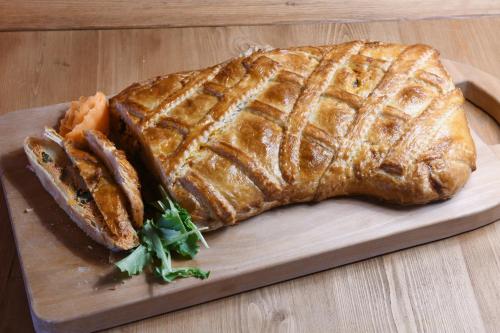 a loaf of bread on a wooden cutting board at Hotel Rascard in Valtournenche