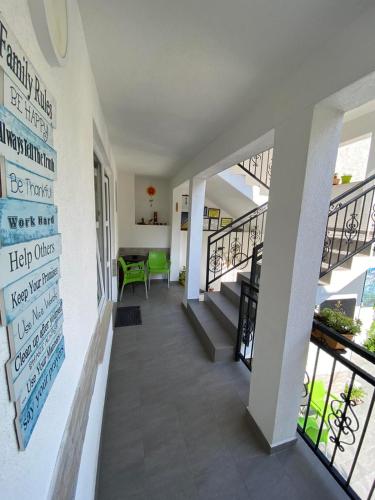 a hallway of a building with a table and chairs at SWEET apartment near Old Town in Mostar