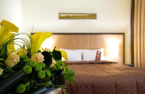 a bed with a flower arrangement on it at Park-Hotel Kidev in Chubynske