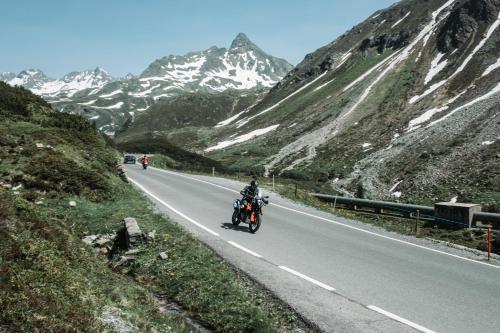 a man riding a motorcycle down a mountain road at Aparthotel Lerch in Kappl