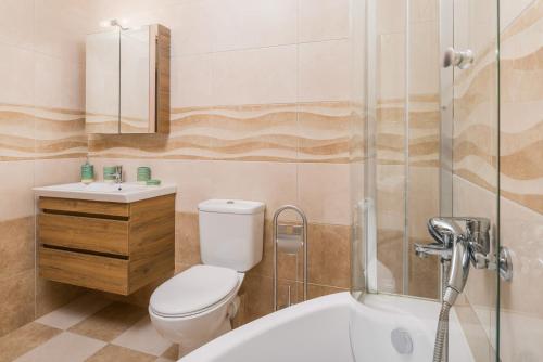 a bathroom with a toilet and a sink and a shower at Faidra Luxury Apartment in Flóka
