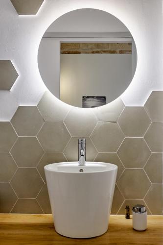 a bathroom with a white sink and a mirror at Mon hotel in Ciutadella