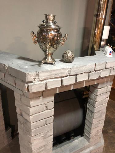 a stone fireplace with a vase on top of it at Girske Povitria 2 in Yaremche