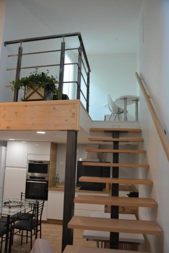 a staircase in a house with a kitchen and a dining room at Acacia in Vienne