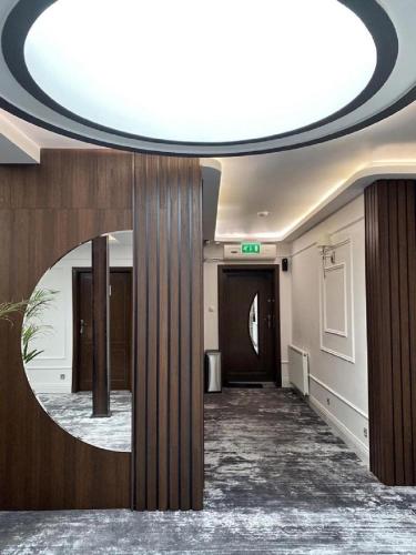 a hallway with a round mirror in a building at Hotel & Restauracja Gniecki in Hrubieszów
