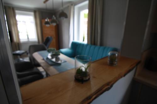 a living room with a blue couch and a table at harz-traum.2 in Gernrode - Harz