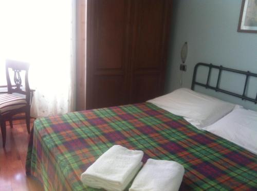 a bedroom with a bed with two towels on it at Ospitalità Collicola in Spoleto