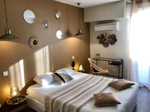 a bedroom with a large bed and a window at A La Voile Blanche in Bouzigues