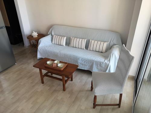 a living room with a couch and a table at Panorama View Apartment 3 in Áyioi Apóstoloi