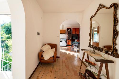 a living room with a mirror and a chair at Borgo Case Lucidi relax in Torano Nuovo