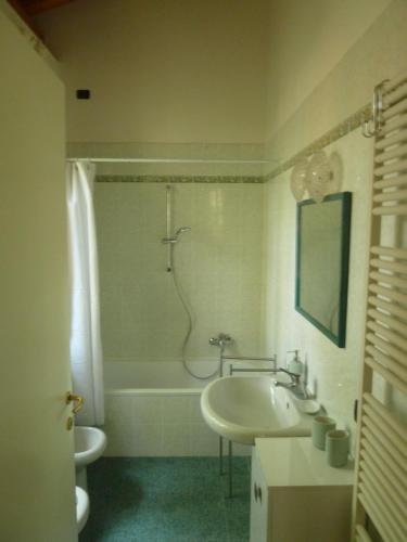 uma casa de banho com uma banheira, um lavatório e um chuveiro em LA STANZA SUI CEDRI - Smart working - Airport - Private Parking - Ducati - Philip Morris em Bolonha