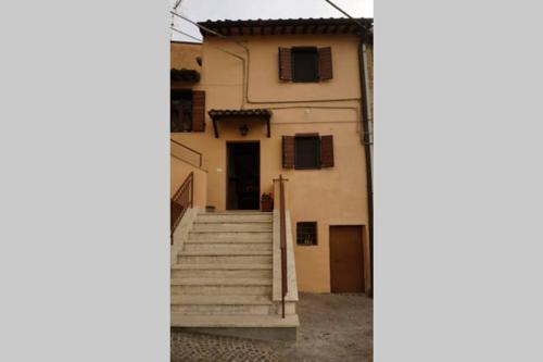 a building with stairs in front of a building at Casa Vacanze da Zia Zarina in Cerdomare