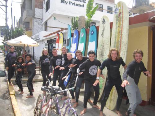 a group of people standing in front of surfboards at My Friend Surf Hostal in Trujillo
