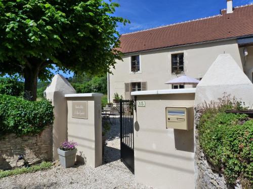a white gate in front of a house at Le Repos Coquelicot in Montillot