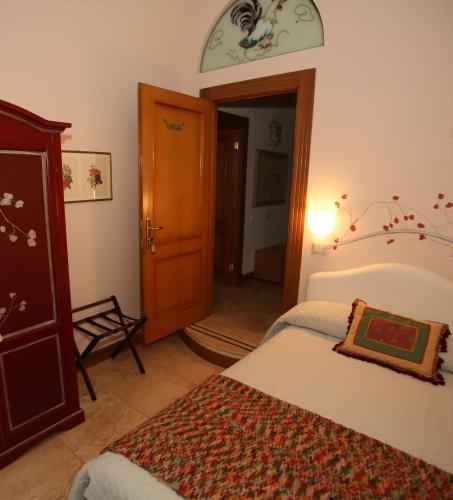 a bedroom with two beds and a clock on the wall at B&B Milu' in Crotone