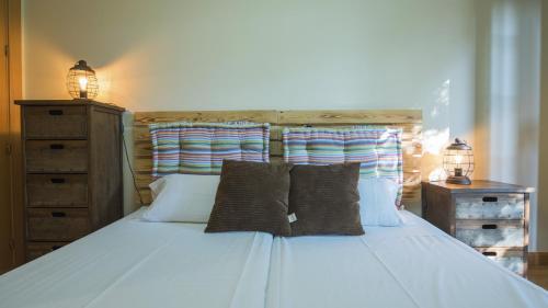 a bedroom with a white bed with two pillows at Sefarad_Parking Propio in Toledo
