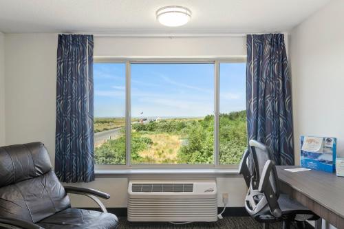 an office with a desk and two chairs and a window at Oceanview Inn at the Arch in Long Beach