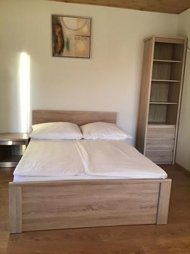 a bed with white sheets and pillows in a room at Agroturystyka Krajno - Zagórze in Krajno-Zagórze