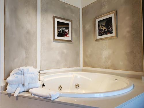 a bathroom with a tub with towels on a counter at Costa Esmeralda Suites in Suances
