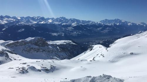a snow covered mountain range with mountains in the background at Apartment Humagne - Crans-Montana Center in Crans-Montana