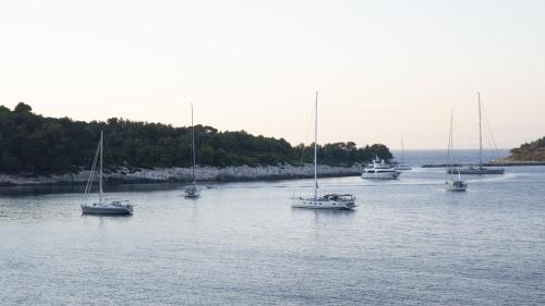 a group of boats sitting in the water at Margina Residence Hotel in Gaios