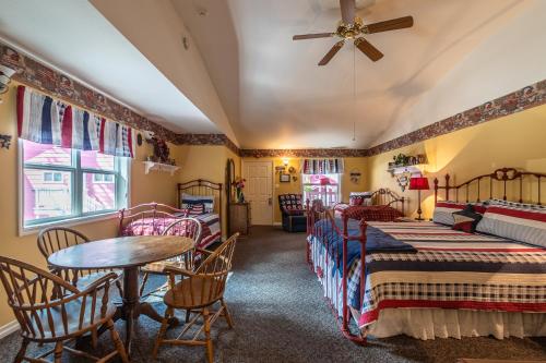 a room with two beds and a table and chairs at Apples Bed and Breakfast Inn in Big Bear Lake