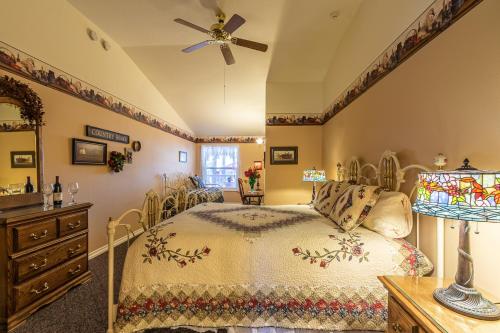 a bedroom with a bed and a ceiling fan at Apples Bed and Breakfast Inn in Big Bear Lake