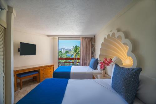 a hotel room with two beds and a television at Park Royal Beach Acapulco - All Inclusive in Acapulco