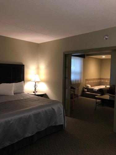 a hotel room with a large bed and a bedroom at Travelodge by Wyndham Winnipeg East in Winnipeg