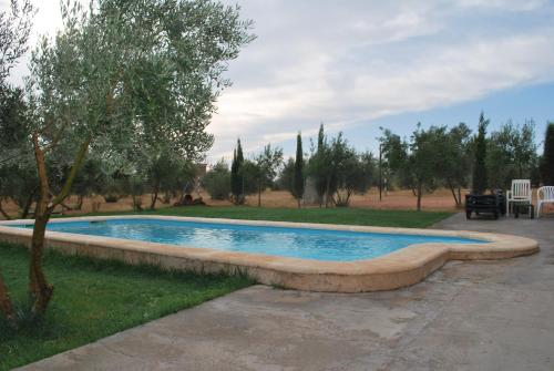 a swimming pool in a yard with trees at Casas Rurales el Palomar in Ossa de Montiel