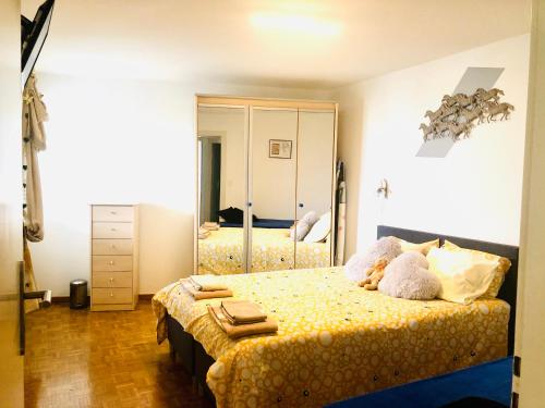 a bedroom with two beds and a large mirror at Lake & Mountain View Apartment I 27 in Montreux