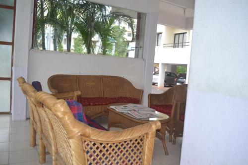 a patio with a table and chairs and a couch at Sorrento Homes in Pune