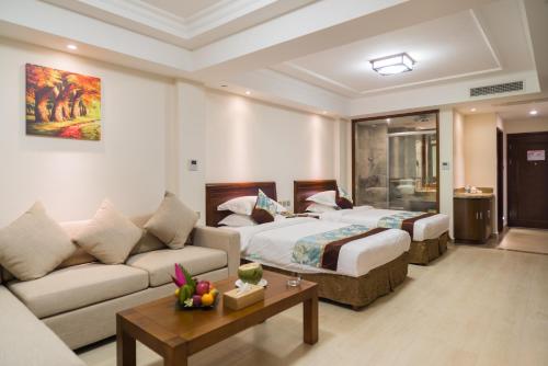 a hotel room with a bed and a couch at Sanya Yikehai View Apartments in Sanya