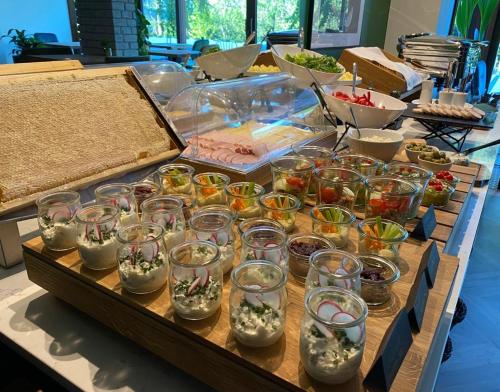 a table with many glass jars filled with plants at Willa Fen in Karpacz