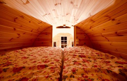 a large bed in a room with wooden walls at Hausdeich in Hamburg