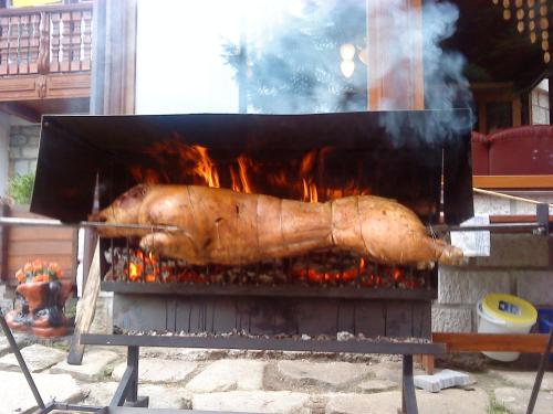 a large pork is cooking on a grill at Penzion Pod Boubínem in Kubova Huť