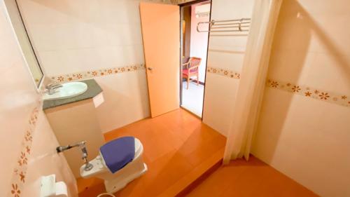 a bathroom with a toilet and a sink at AA Pattaya Ville in Pattaya Central