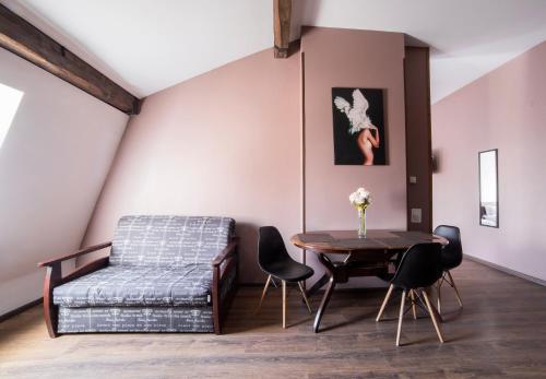 a room with a bed and a table and chairs at Apartment on Lychakivska in Lviv