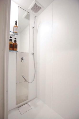 a bathroom with a shower with a glass door at Kyoto Nina in Kyoto